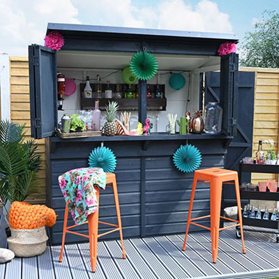 a wooden garden bar, painted black and decorated