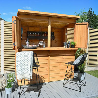 a wooden garden bar with drinks and seats