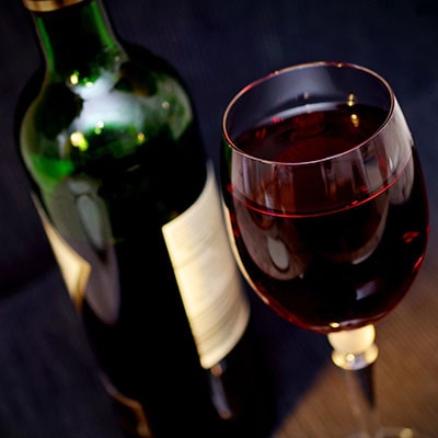 a wine bottle and glass of red wine