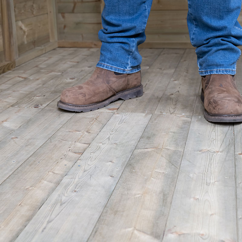 a man stood on a Forest Premium Shed tongue and groove floor