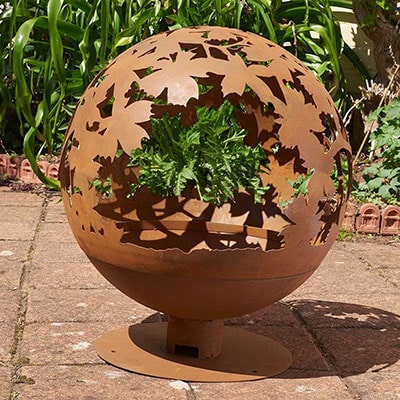 a decorative, brown, circular fire pit bowl