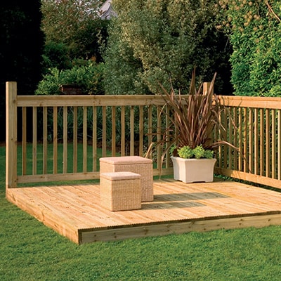 a square patio deck kit with railings, a planter and stools
