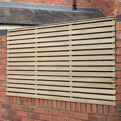 a 6x3 double-slatted fence panel mounted on top of a brick wall