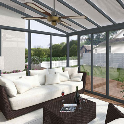 a grey polycarbonate conservatory full of garden furniture
