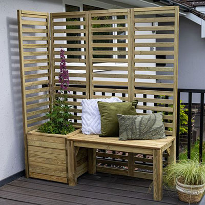 a wooden garden bench, planter and slatted panels