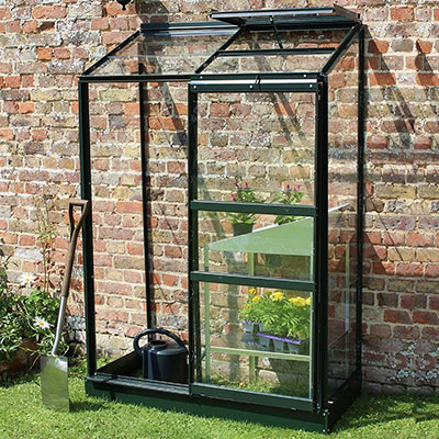 a lean-to greenhouse with a green frame and open roof vents