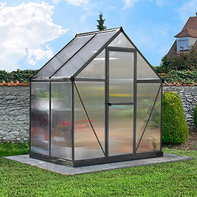 a small polycarbonate greenhouse with a grey frame