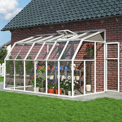 a white-framed lean-to sun house full of plants