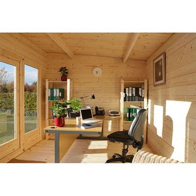 a log cabin interior, set up as a garden office