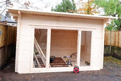 a partially assembled log cabin
