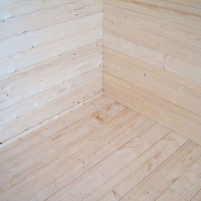a garden building's wall and floor, made from tongue and groove cladding