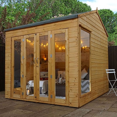 A wooden summer house with 12mm tongue and groove cladding, as well as bi-fold doors