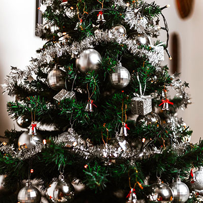a Christmas tree with silver baubles and tinsel 