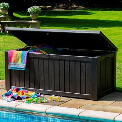 a brown plastic storage box next to a swimming pool