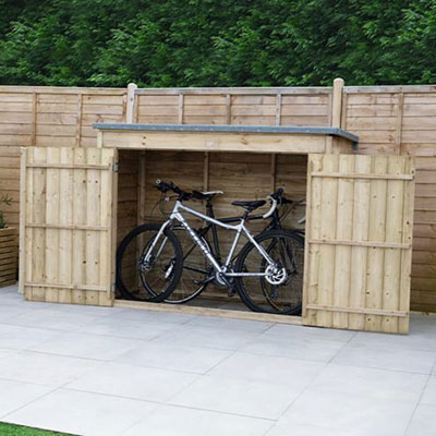 a wooden bike shed, featuring wide double doors, and containing 2 adult bikes