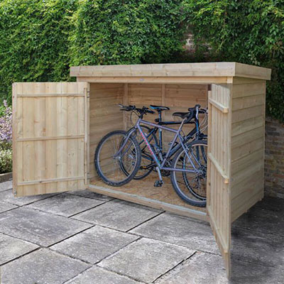 a pent wooden bike shed containing 2 bicycles