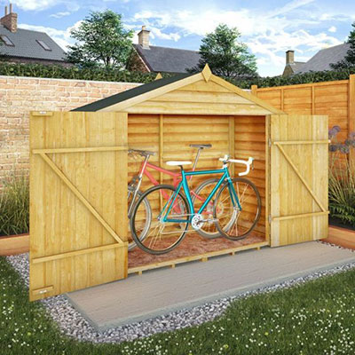 2 bikes inside a wooden bicycle storage unit