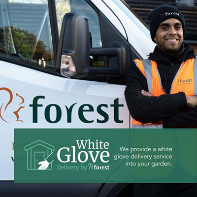 a Forest summerhouse delivery man standing next to his white van