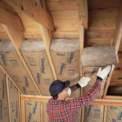 A Photo of a man fitting Insulation