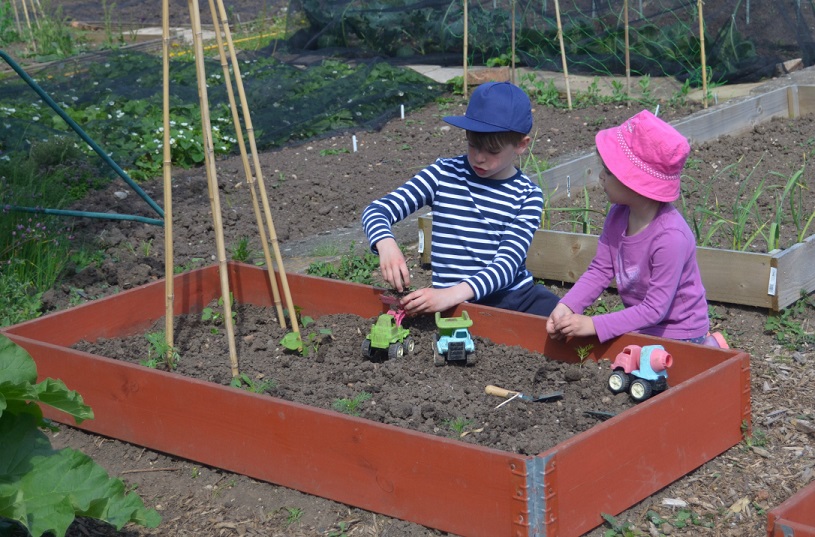 children pottering in the garden