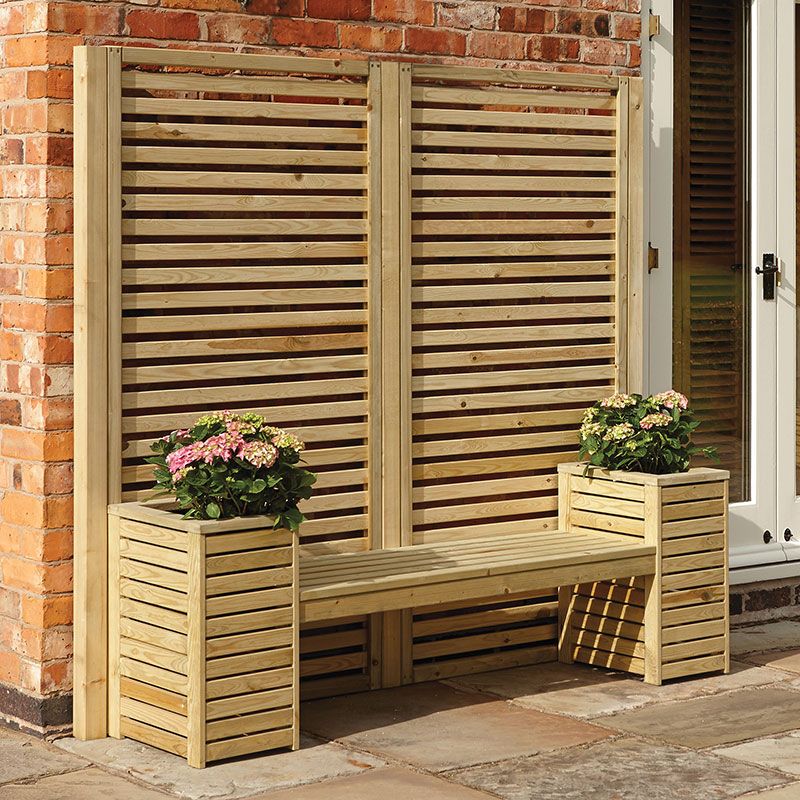 A wooden garden bench with planters positioned either side and a decorative, wooden screen to the rear.