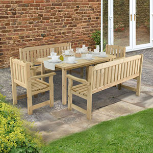 The Forest 8-Seater Wooden Garden Table and Chairs, laid with cups and saucers and situated on a patio.