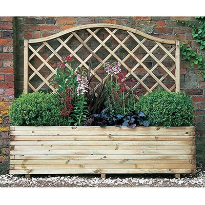 A wooden container with a trellis back and plants growing inside