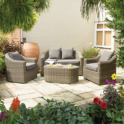 a 4-piece rattan garden sofa set on a patio