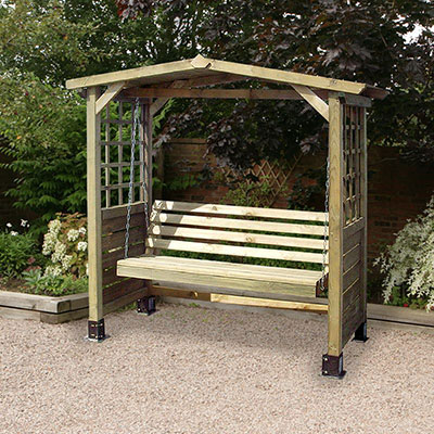 A wooden garden swing seat arbour with trellis sides.